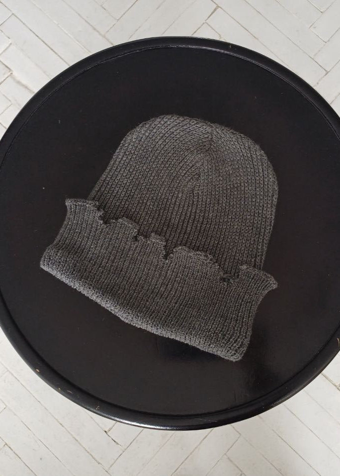 The raps cap is torn, light gray