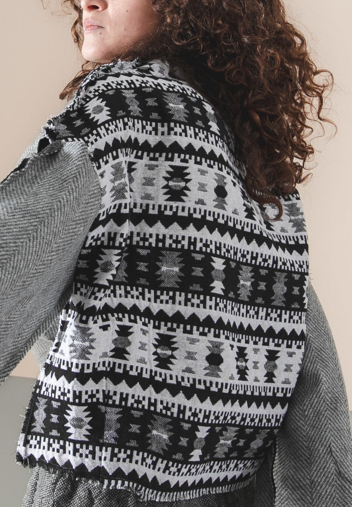 Gray open shoulder sweater with an ornament