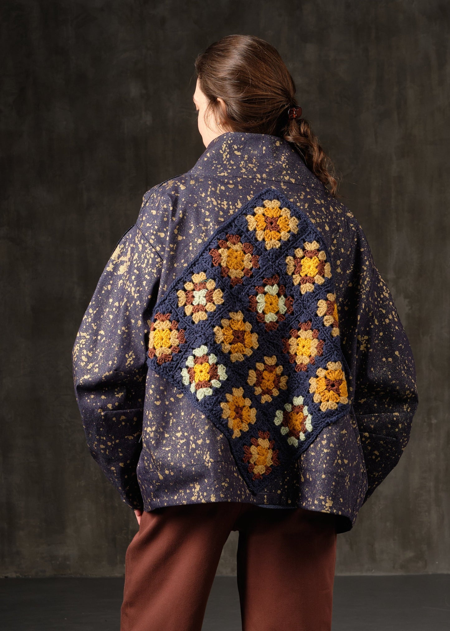 Denim bomber jacket in ink with gold detailing on the back