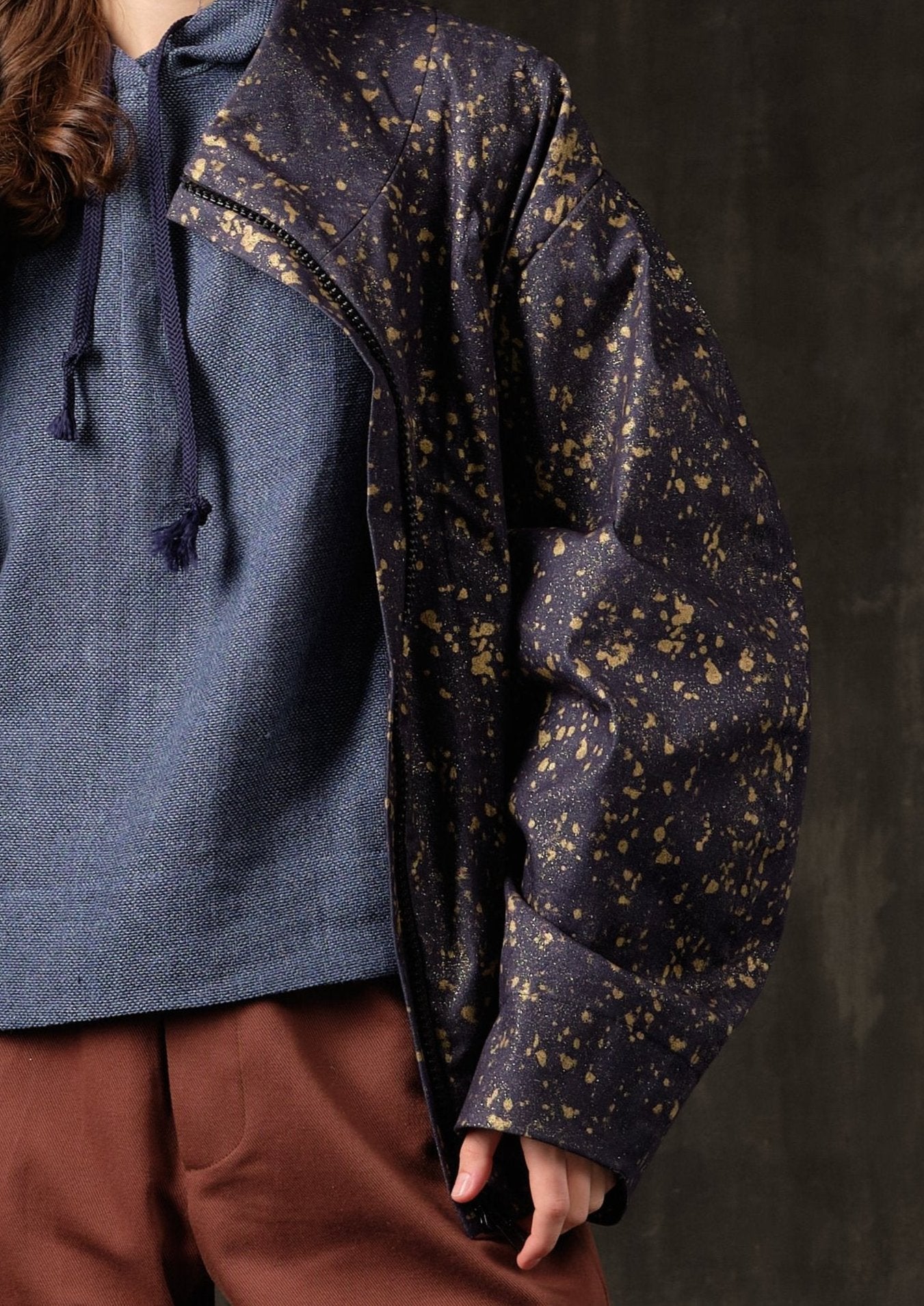 Denim bomber jacket in ink with gold detailing on the back