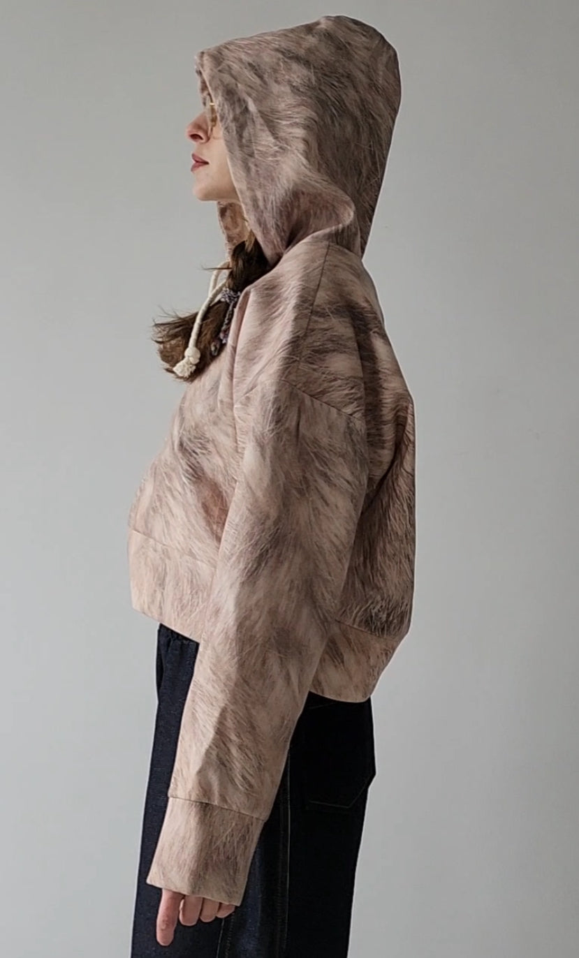 Short woolen hoodie with an abstract print