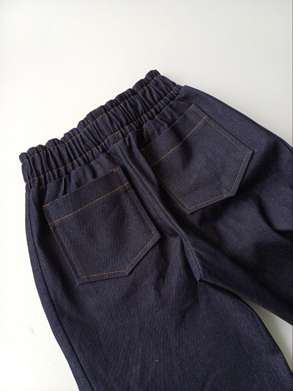 Wide, tight jeans with stripes and fringe