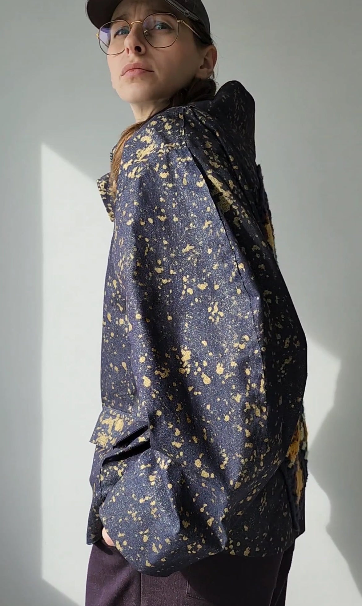 Denim bomber jacket in ink with gold detailing on the back