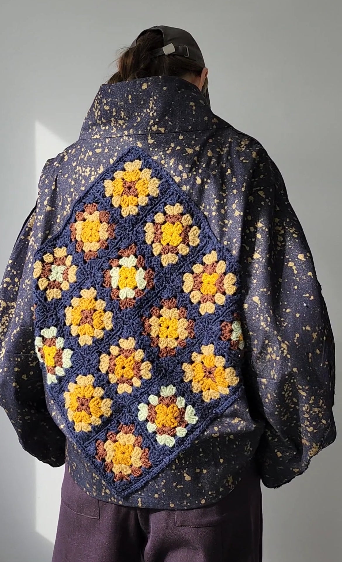 Denim bomber jacket in ink with gold detailing on the back