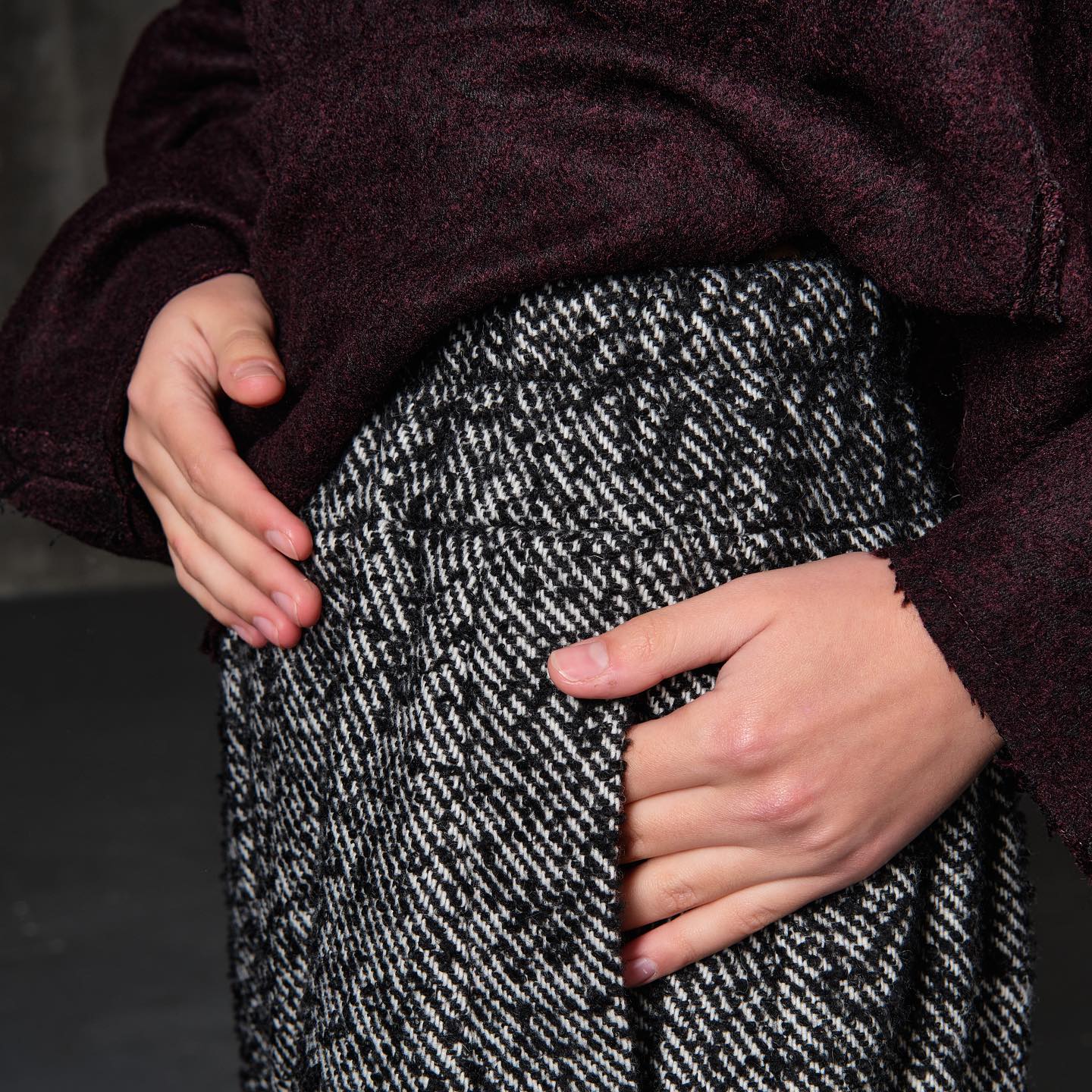 Open-shoulder burgundy wool sweater with a rose back