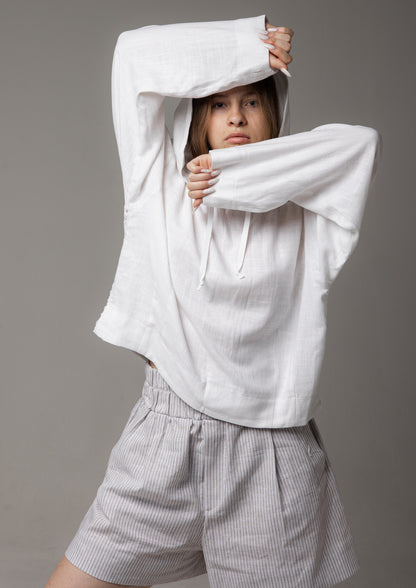 A white linen shirt with a hood and a mesh back