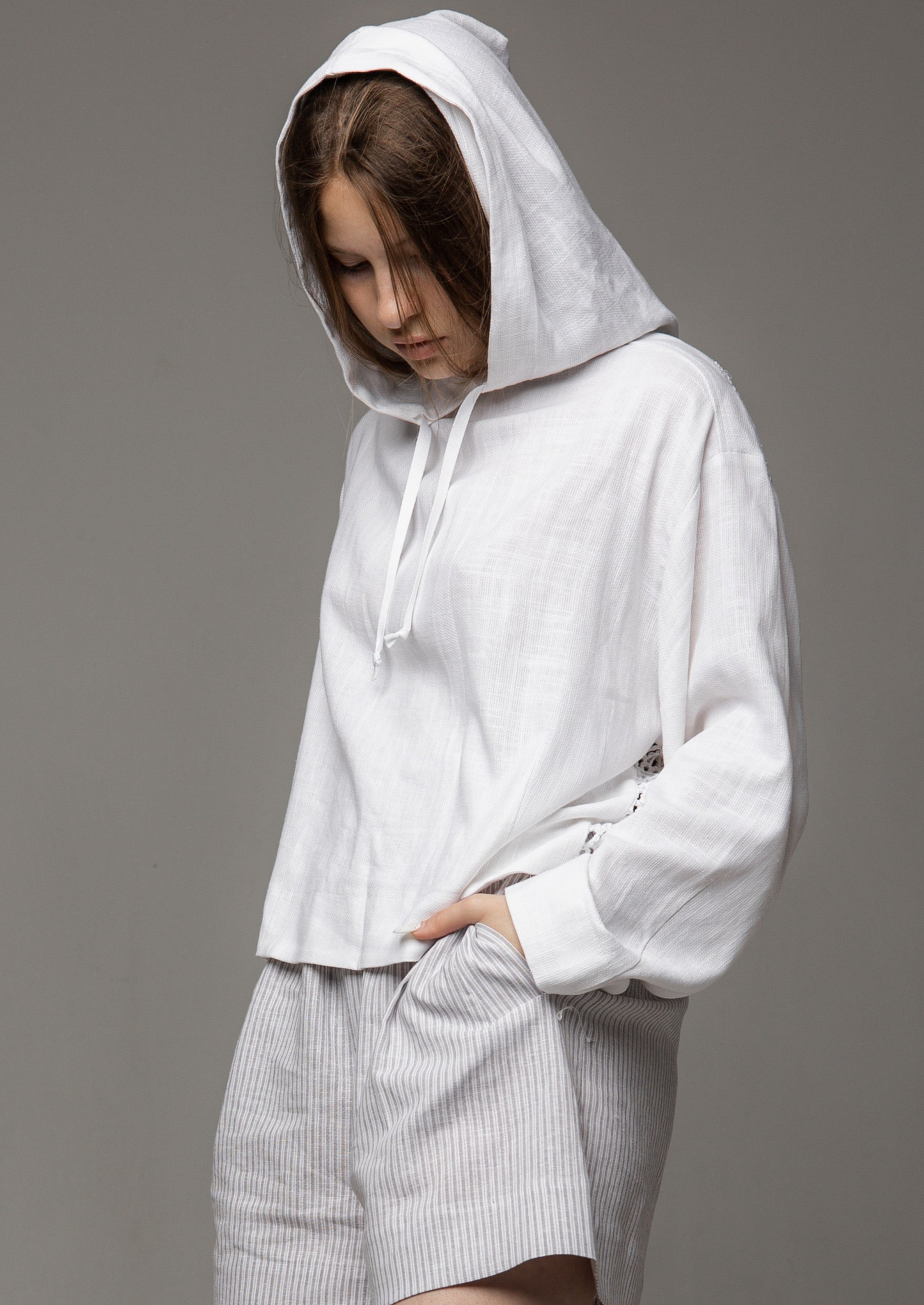 A white linen shirt with a hood and a mesh back