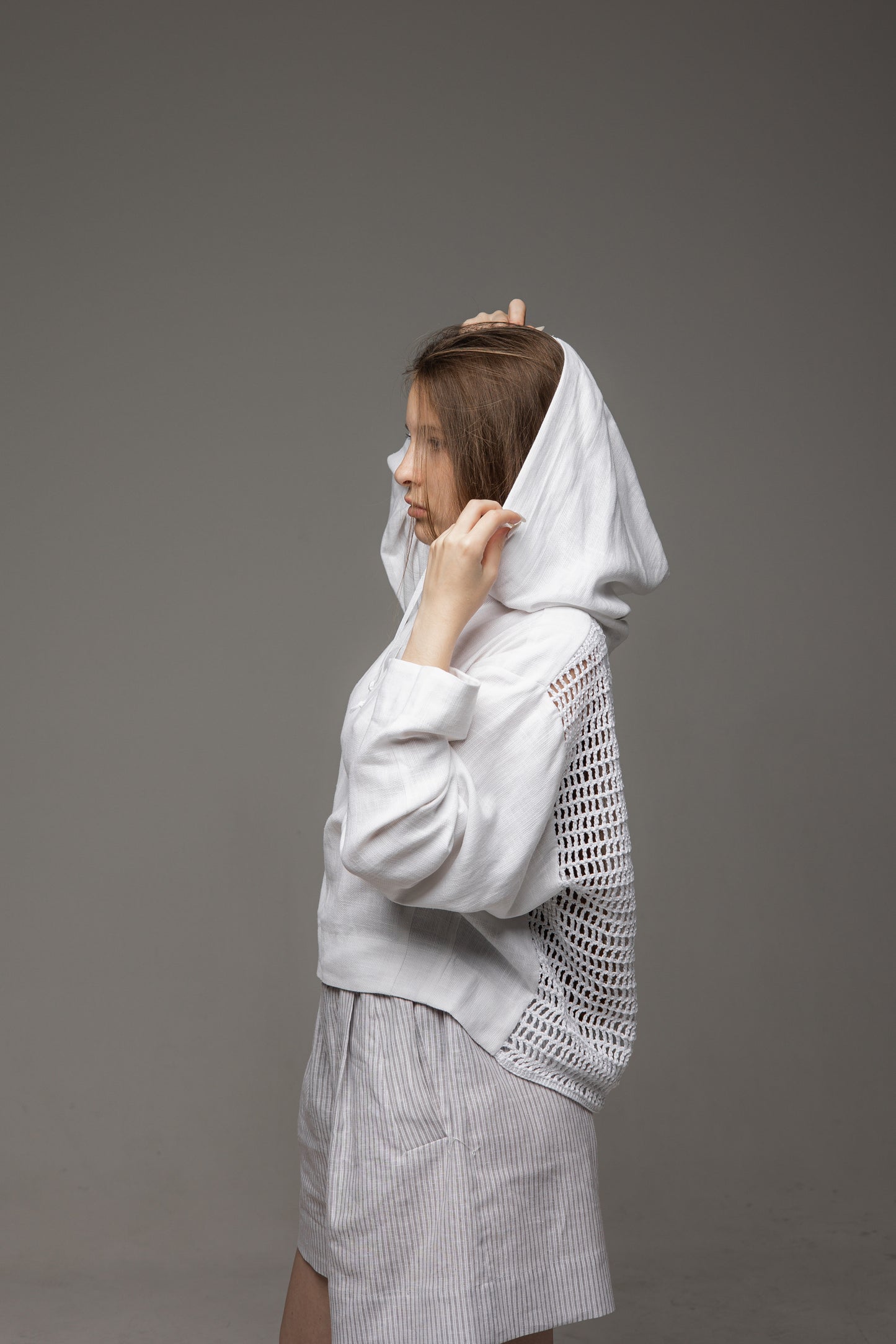 A white linen shirt with a hood and a mesh back