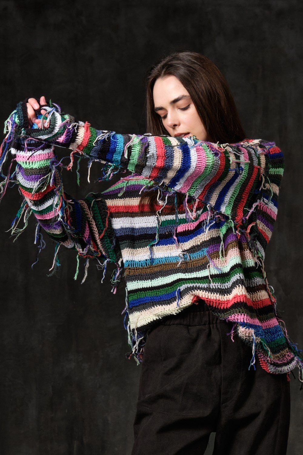 Hand-knitted sweater of rasta stripes with threads