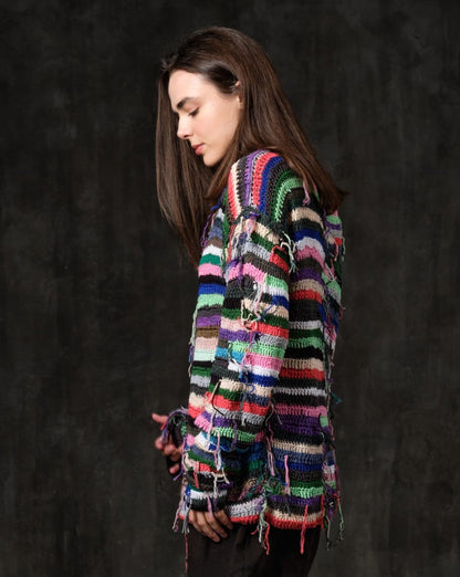 Hand-knitted sweater of rasta stripes with threads