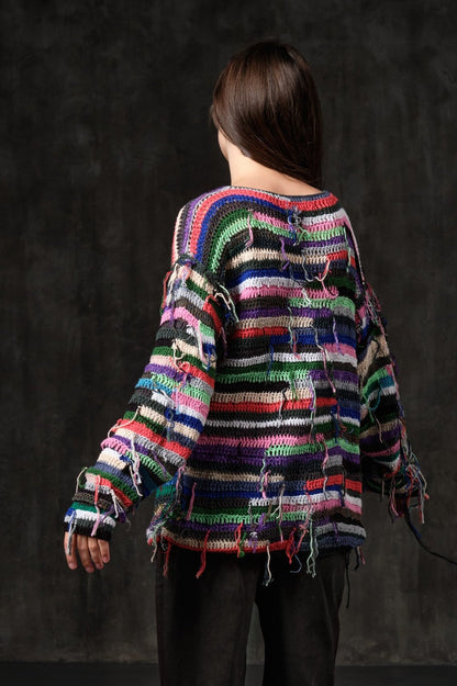 Hand-knitted sweater of rasta stripes with threads