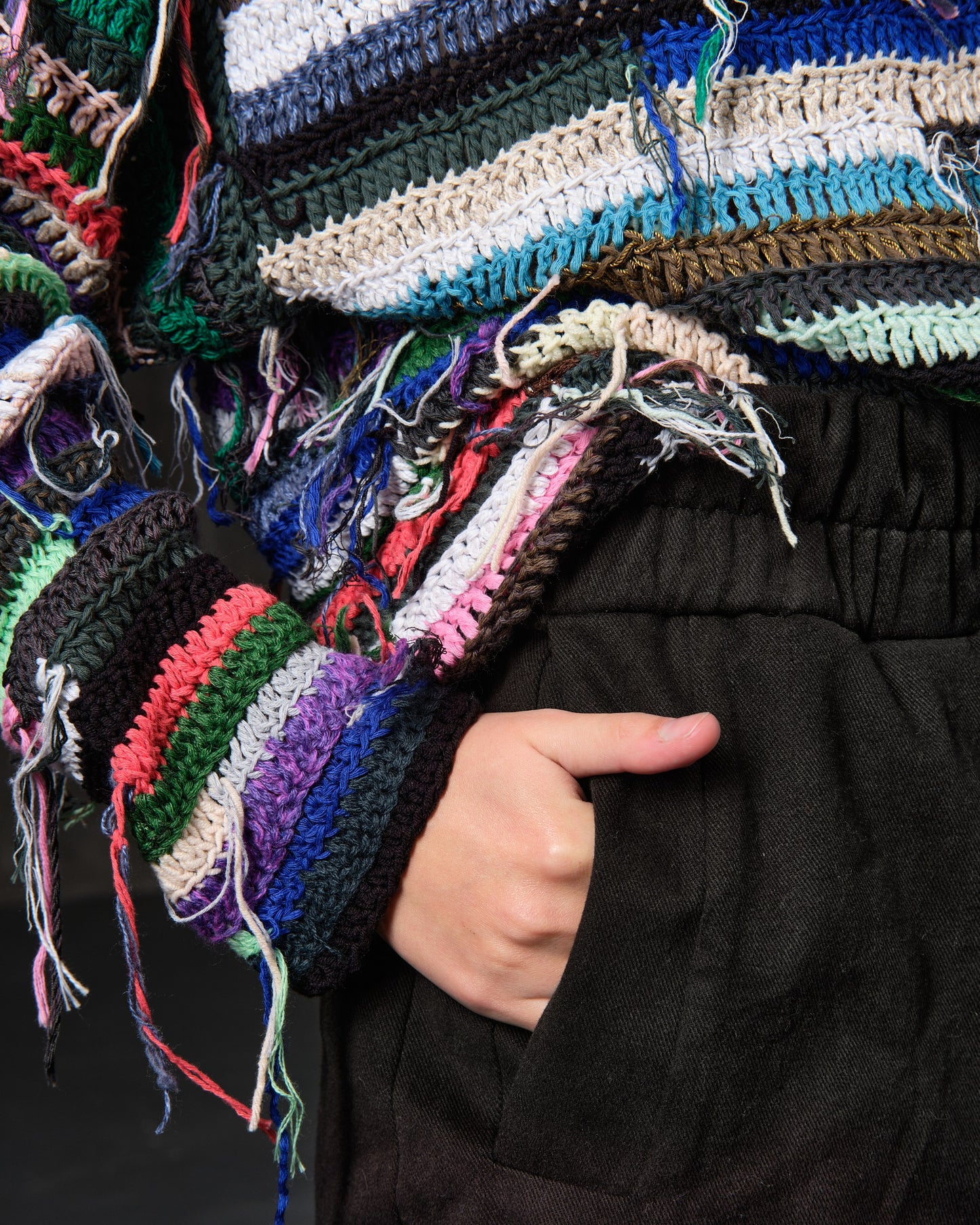 Hand-knitted sweater of rasta stripes with threads