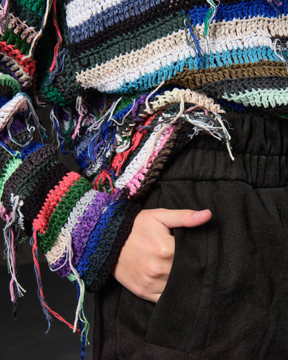 Hand-knitted sweater of rasta stripes with threads