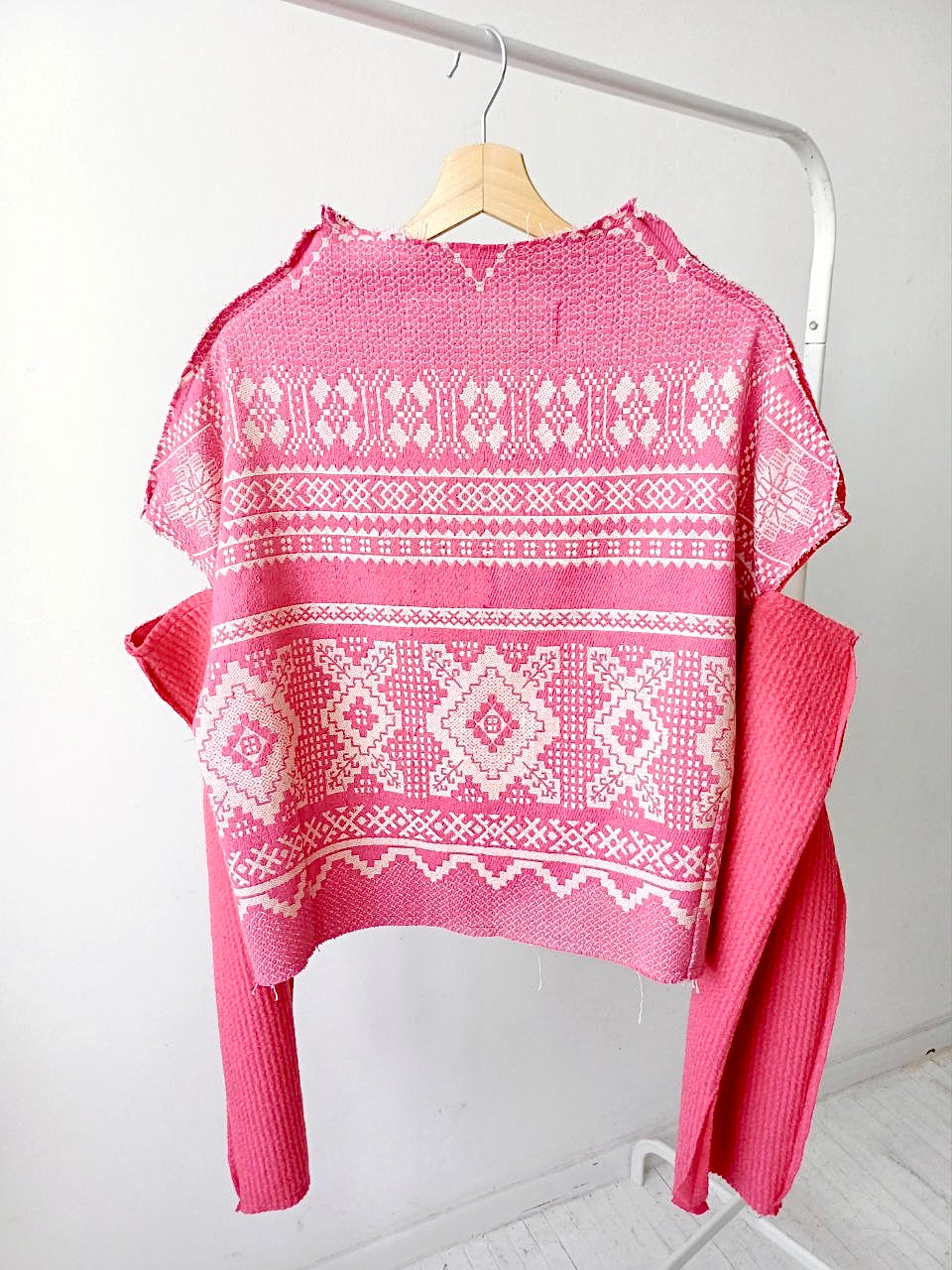 Ethnic sweater with black drape and pink geometry